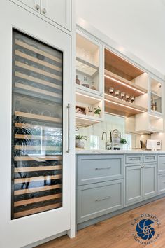 Pictured is a featured image from E.L. Designs, Serene Sanctuary Whole Home Remodel, showing a new built in wet bar with a full-size wine fridge and matching pantry storage.