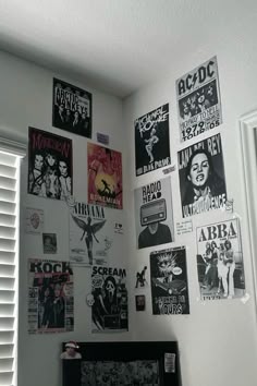 a bedroom with posters on the wall and a bed