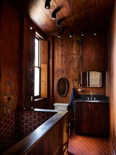 a bathroom with wood paneling and tile flooring