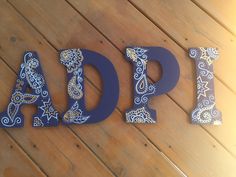 the word dad spelled out in blue and white with paisley designs on it's letters