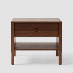 the side table is made from wood and has an open drawer on one side, with two