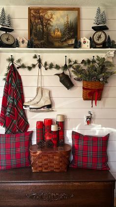 christmas decorations are displayed on the wall above an old trunk with stockings and boots hanging from it