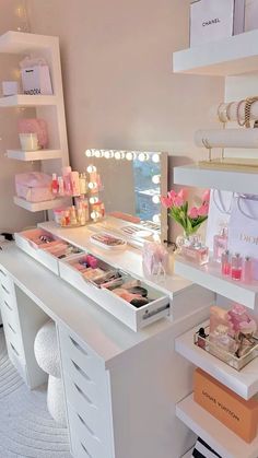 a white desk topped with lots of drawers and shelves filled with makeup products on top of it