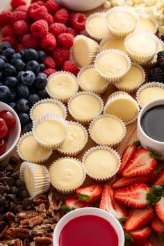 cupcakes, berries, and other dessert ingredients are arranged on a table