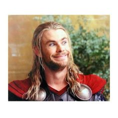 a man with long hair wearing a red shirt