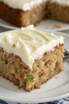 a piece of cake with white frosting on a plate