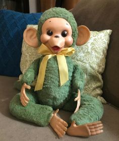 a stuffed monkey sitting on top of a couch