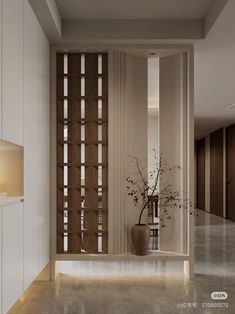 a vase with flowers in it is sitting on the floor next to an open door