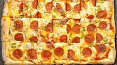 a square pizza with pepperoni and green peppers