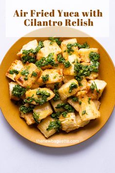 a yellow plate topped with tofu and spinach