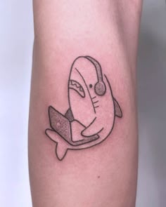 The online surfing shark tattoo by @pigeonpokes Tattoo Tiburon, Tattoo Ideas For Thighs, Happy Shark Tattoo, Cute Simple Shark Tattoo, Baby Shark Tattoo, Small Tattoos Shark, Lil Shark Tattoo, Blahaj Tattoo, Shark Simple Tattoo