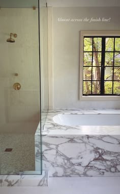a bathroom with marble flooring and walls