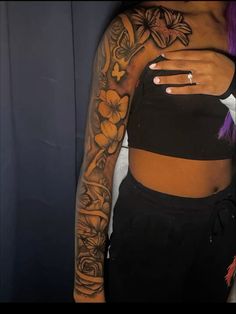 a woman with purple hair and tattoos on her arm