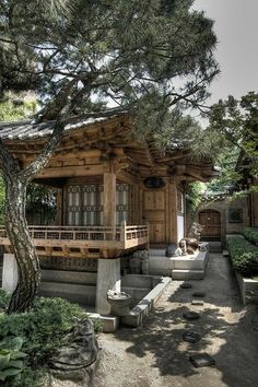 a small wooden building sitting under a tree
