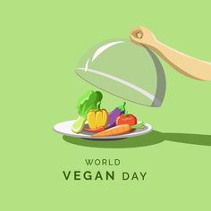 a person holding a platter with vegetables on it and the words world vegan day
