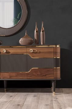 a sideboard with two vases and a mirror on the wall