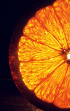 an orange cut in half sitting on top of a table