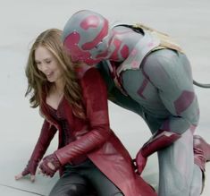 two people dressed in costumes crouching down to touch each other's chestes