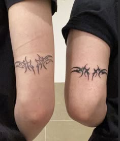 two people with matching tattoos on their legs