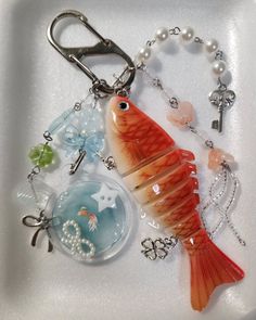 a keychain with a fish and charms on it