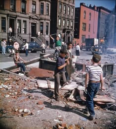 children are playing in the rubble on a city street