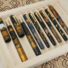 an assortment of fountain pens in a box