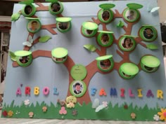 the family tree is made out of cardboard and decorated with green leaves, branches, and pictures