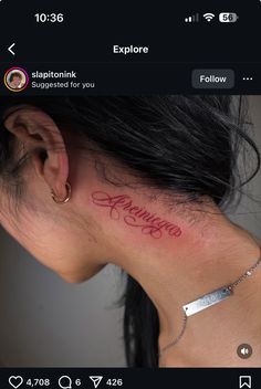 the back of a woman's neck has a tattoo on it