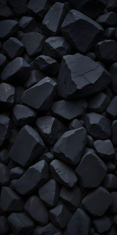 a pile of black rocks sitting next to each other