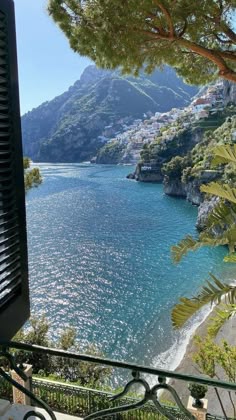 a view of the ocean and mountains from a balcony in positi, italy