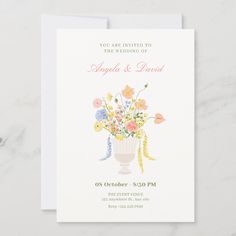 a wedding card with flowers in a vase