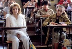 several people sitting at desks in a classroom