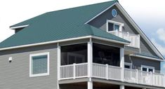 a large gray house with white balconies