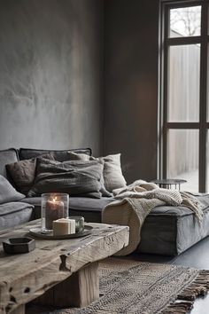 a living room filled with lots of furniture and a candle on top of a table