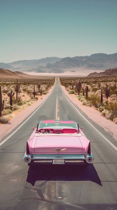 an old pink car is driving down the road