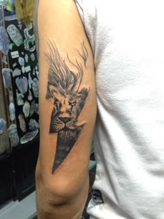 a man with a tattoo on his arm has a lion and lightning bolt in it