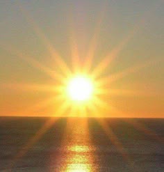 the sun is setting over the ocean and it appears to be reflecting off the water