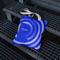 a blue and white bag sitting on some metal grates