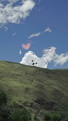 there are clouds and butterflies flying in the sky over a hill side with trees on it