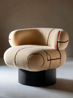 a white chair sitting on top of a black pedestal