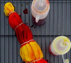 two blenders with different colored liquids next to each other on a metal rack