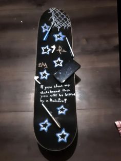 a black skateboard with blue and white stars on it