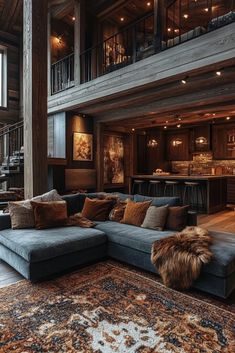 a living room filled with furniture and lots of woodwork on the walls next to a spiral staircase