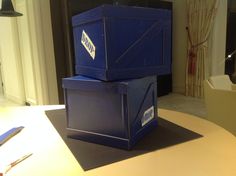 two blue boxes sitting on top of a table