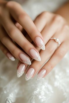 a woman's hand with long, shiny nails and white laces on it