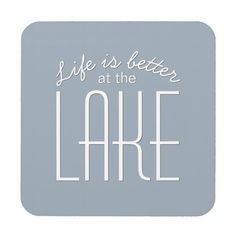 a square coaster with the words life is better at the lake in white on a light blue background