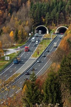 an aerial view of a highway with cars and trucks driving on it's sides