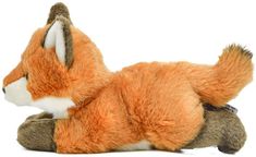 a stuffed fox laying down on the ground