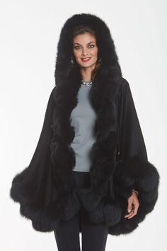 Black Cashmere Cape - Detachable Hood - MarquessaCape Content: Fine quality 100% cashmere. Fur Content: Black Dyed Fox. Fur Origin: Finland. Cape length from center back to hemline: 30". Cape can be worn with or without hood. Hook and eye closure at neckline. Perfect for both regular and plus sizes.$1,095.00https://www.madisonavenuemalls.com/shop/cashmere/cashmere-capes-wraps-stoles/black-cashmere-cape-detachable-hood-marquessa/ Cape Outfit Winter, Fitted Black Winter Cape, Elegant Black Poncho Cape, Black Cape With Fur, Men Fur Hat, Black Faux Fur Cape, Luxury Black Cape Sleeved Outerwear, Cape Outfit, Mens Fur Coat