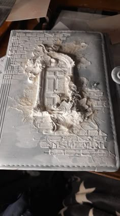 a book covered in white frosting sitting on top of a table